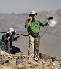 (scientist recording in the field)